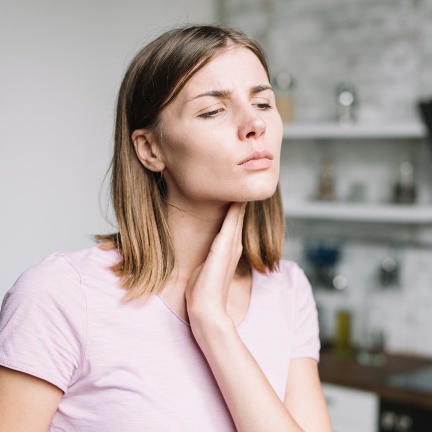 Medical illustration showing an overactive thyroid gland in the neck indicating hyperthyroidism.