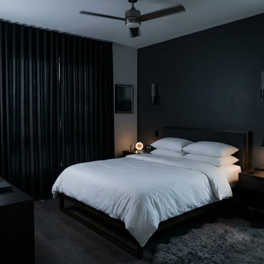 cool dark bedroom set at best temperature for sleep with blackout curtains and clean white bedding